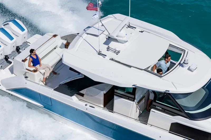 Slide: The Image of Manufacturer Provided Image: 2026 Tiara Yachts 46 LS cruising on turquoise waters with passengers enjoying the ride. - 2