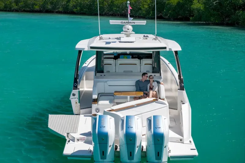 Slide: The Image of Manufacturer Provided Image: 2026 Tiara Yachts 46 LS cruising on turquoise waters with passengers relaxing onboard. - 5