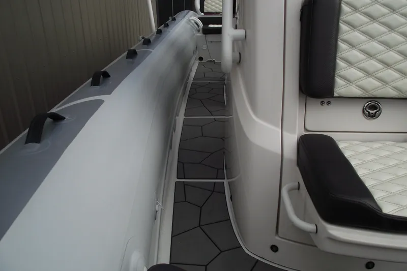 Slide: The Image of 2024 Highfield Sport 760 boat interior with quilted seating and sleek design. - 13