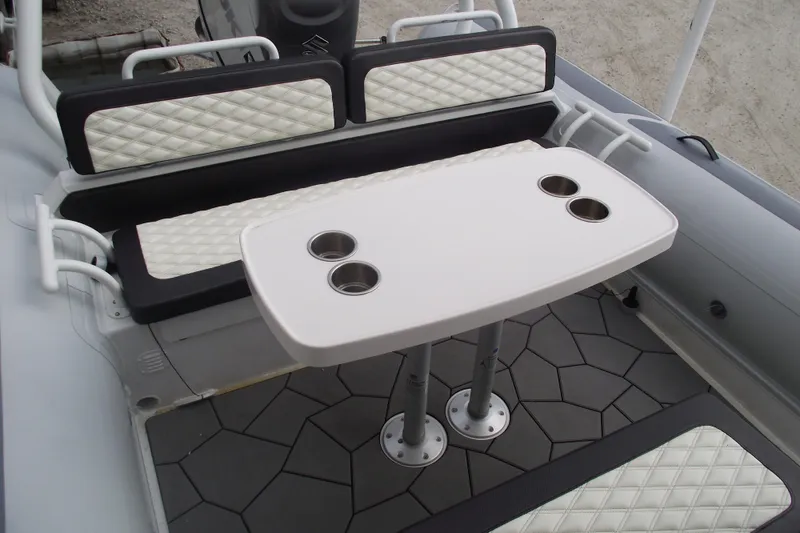 Slide: The Image of 2024 Highfield Sport 760 boat interior with seating and table featuring cup holders. - 15