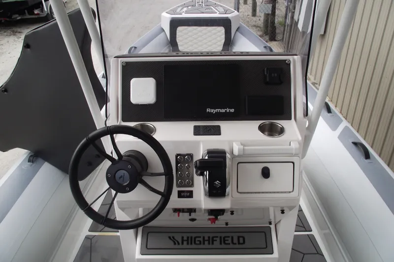 Slide: The Image of 2024 Highfield Sport 760 boat dashboard with steering wheel and Raymarine navigation system. - 17