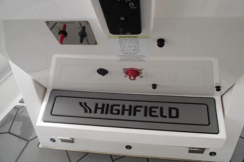 Slide: The Image of 2024 Highfield Sport 760 boat interior with control panel and branding. - 18
