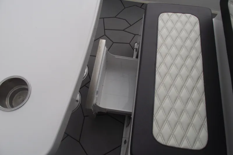 Slide: The Image of 2024 Highfield Sport 760 boat interior with diamond-stitched seating and storage compartment. - 22