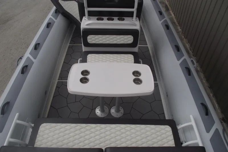Slide: The Image of 2024 Highfield Sport 760 boat interior with seating and table, featuring cup holders and modern design. - 27