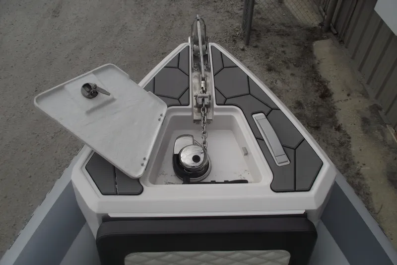 Slide: The Image of 2024 Highfield Sport 760 boat anchor compartment with open hatch and chain detail. - 7