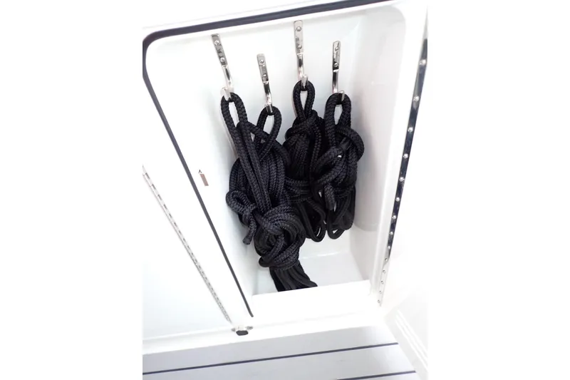 Slide: The Image of Storage compartment with black ropes on a 2024 Formula 400 Super Sport Crossover boat. - 12