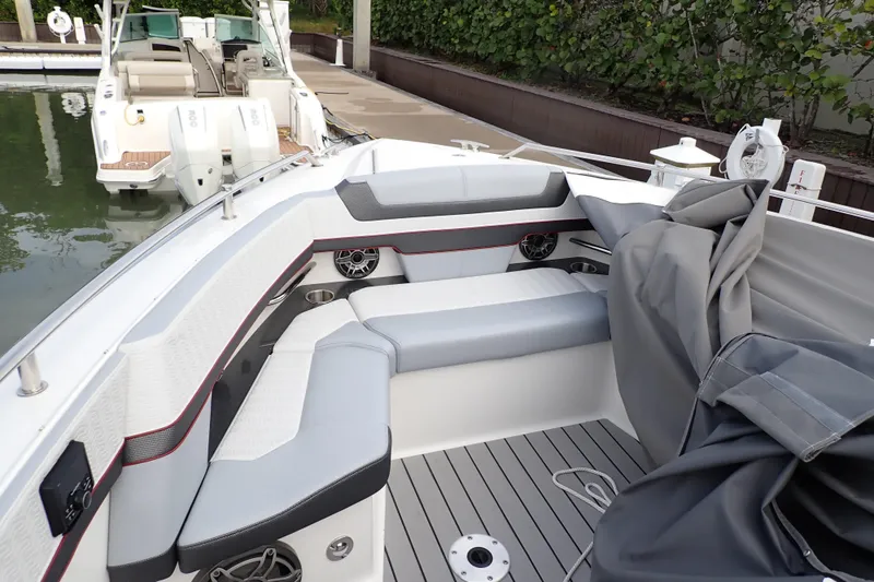 Slide: The Image of 2024 Formula 400 Super Sport Crossover boat interior with seating and speakers at dock. - 22