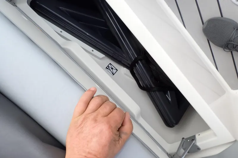 Slide: The Image of Hand accessing storage compartment on 2024 Formula 400 Super Sport Crossover boat. - 30