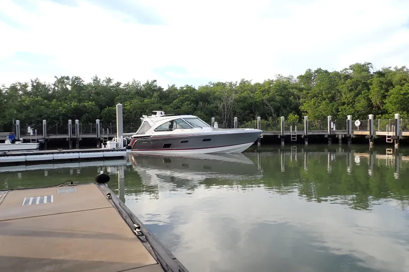 Slide: The Image of 2024 Formula 400 Super Sport Crossover docked in a serene marina setting. - 4