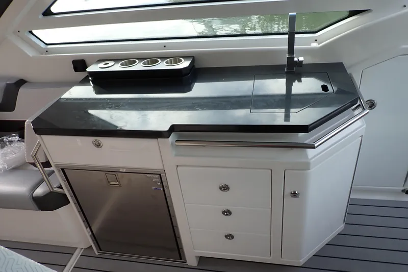 Slide: The Image of 2024 Formula 400 Super Sport Crossover yacht kitchenette with sleek countertop and modern fixtures. - 6