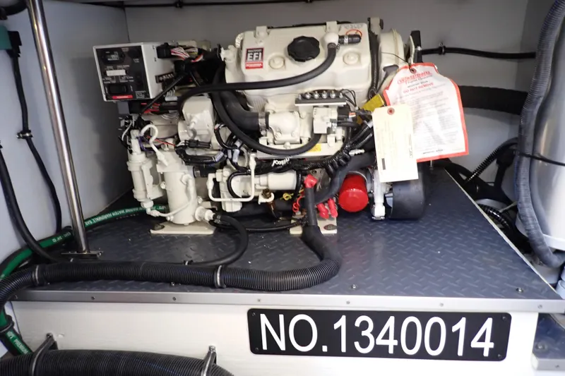 Slide: The Image of Engine compartment of 2024 Formula 400 Super Sport Crossover with visible wiring and components. - 7