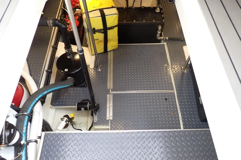 Slide: The Image of Engine room of 2024 Formula 400 Super Sport Crossover with diamond plate flooring and equipment. - 9