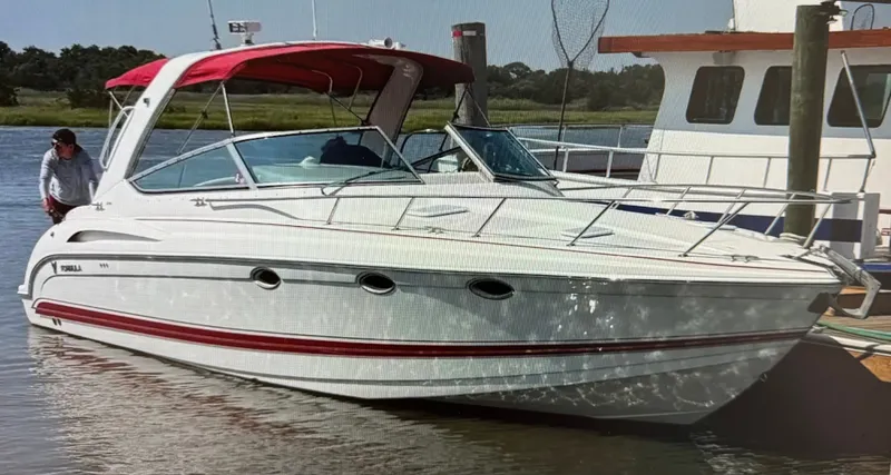 Slide: The Image of 2001 Formula 37 Super Sport boat docked with red canopy. - 0