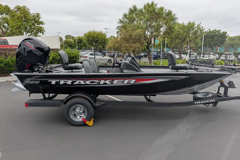 The Image of 2026 Tracker Pro Team 195 TXW boat on trailer, parked outdoors. - 1