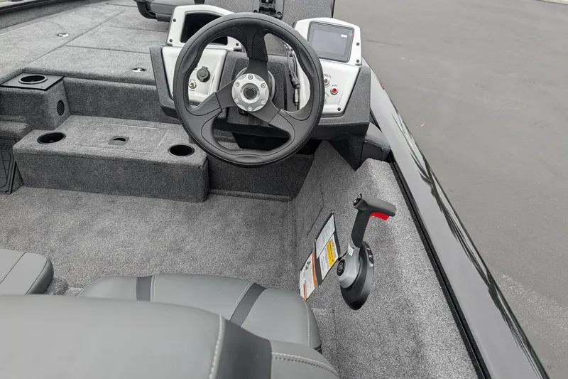 Slide: The Image of 2026 Tracker Pro Team 195 TXW boat interior with steering wheel and control panel. - 11