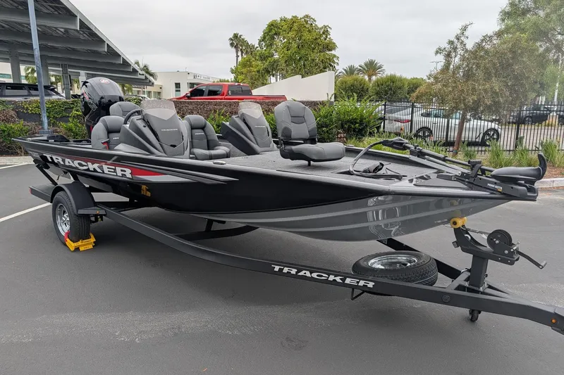 Slide: The Image of 2026 Tracker Pro Team 195 TXW fishing boat on trailer in parking lot. - 3