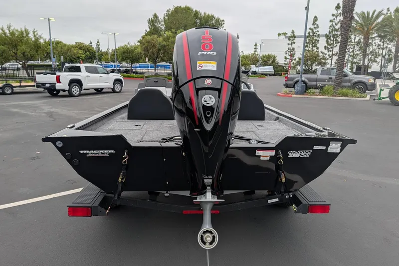 Slide: The Image of 2026 Tracker Pro Team 195 TXW boat with powerful 150 HP engine, parked outdoors. - 6
