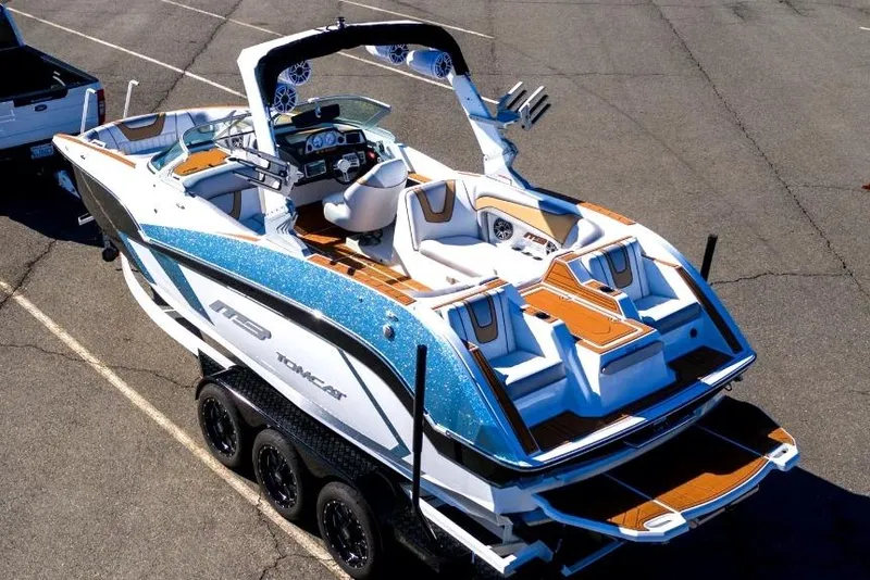 The Image of 2021 MB F24 Tomcat boat on trailer, featuring sleek design and luxurious seating. - 0