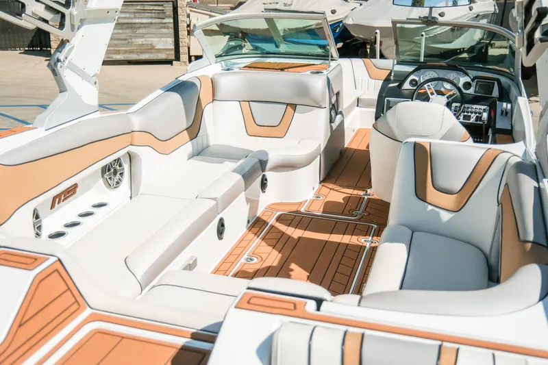 Slide: The Image of 2021 MB F24 Tomcat boat interior with luxurious seating and modern dashboard. - 11