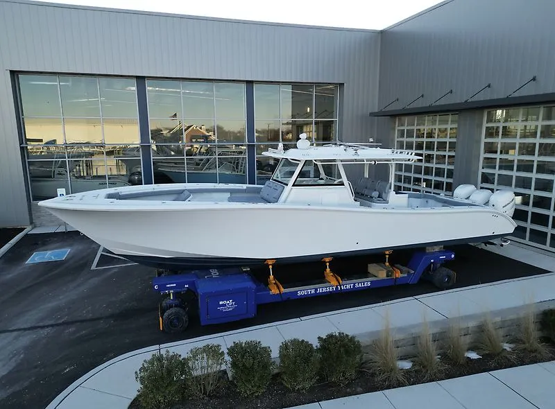 Slide: The Image of 2022 Yellowfin 42 Offshore boat in front of a modern building. - 1