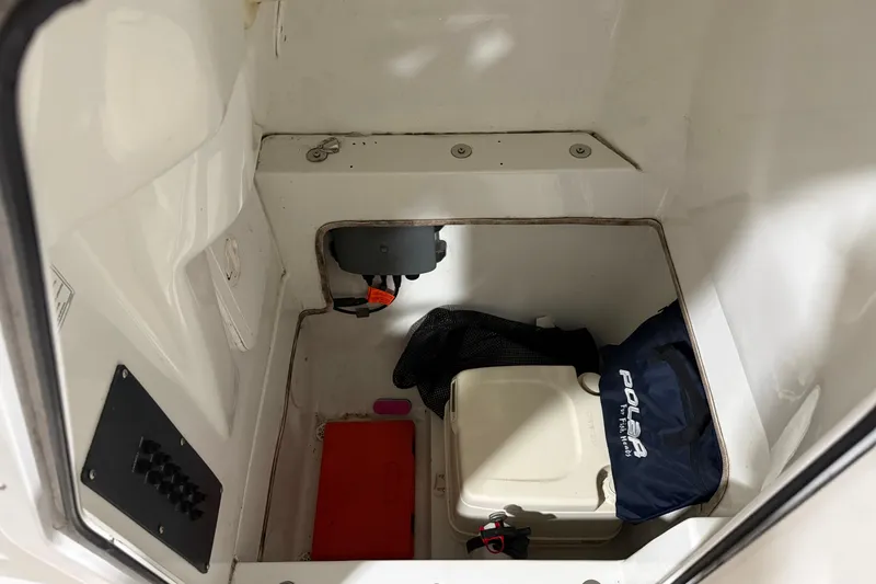 Slide: The Image of Interior storage compartment of a 2007 Polar 2300 Center Console boat with equipment. - 14