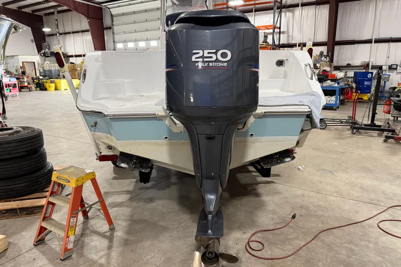 Slide: The Image of 2007 Polar 2300 Center Console boat with 250 horsepower outboard motor in a workshop. - 16