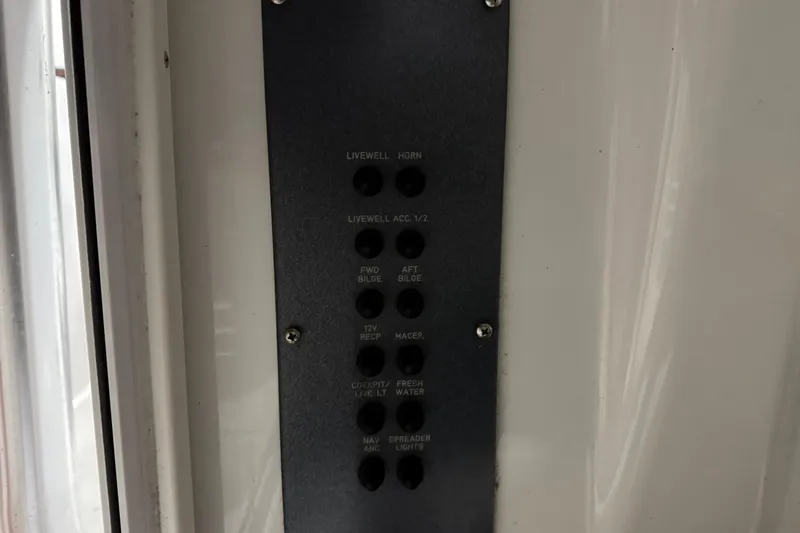 Slide: The Image of Control panel on a 2007 Polar 2300 Center Console boat, featuring various switches. - 18