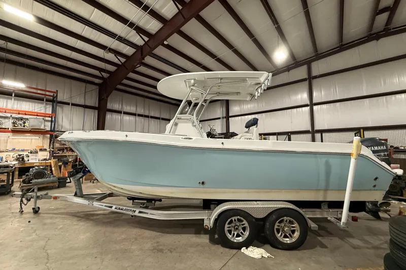 Slide: The Image of 2007 Polar 2300 Center Console boat on trailer in a warehouse setting. - 2