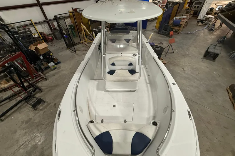 Slide: The Image of 2007 Polar 2300 Center Console boat in a workshop, showcasing spacious deck and seating. - 6