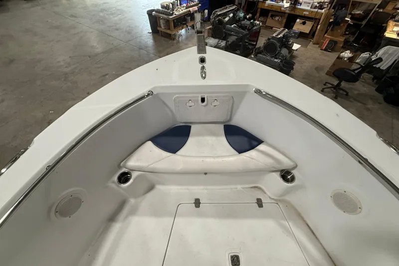 Slide: The Image of 2007 Polar 2300 Center Console boat interior with seating and storage in a workshop. - 7