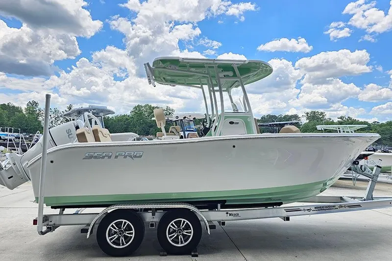 The Image of 2026 Sea Pro 225FLX Sandbar boat on trailer under a vibrant blue sky. - 1