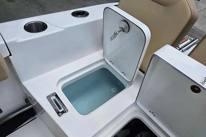 Slide: The Image of Open storage compartment on 2026 Sea Pro 225FLX Sandbar boat with cup holders. - 13