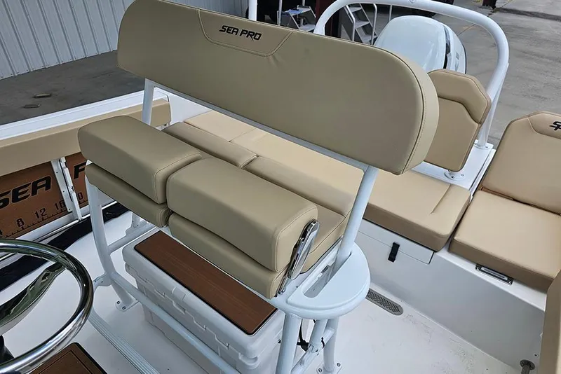 Slide: The Image of 2026 Sea Pro 225FLX Sandbar boat interior with beige seating and steering wheel. - 15