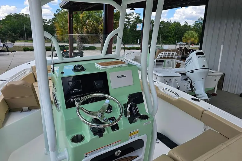 Slide: The Image of 2026 Sea Pro 225FLX Sandbar boat interior with steering wheel and Simrad electronics. - 16