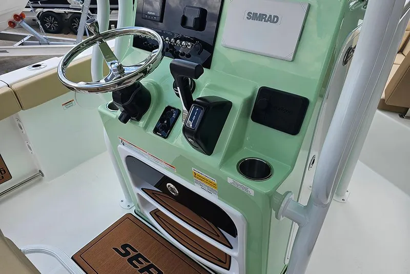 Slide: The Image of 2026 Sea Pro 225FLX Sandbar boat console with steering wheel and Simrad electronics. - 18