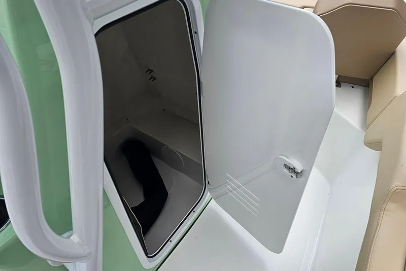 Slide: The Image of Open storage compartment on 2026 Sea Pro 225FLX Sandbar boat, featuring beige seating. - 20