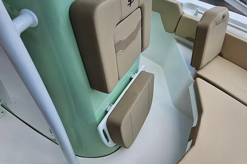 Slide: The Image of 2026 Sea Pro 225FLX Sandbar boat interior with tan seating and green accents. - 22