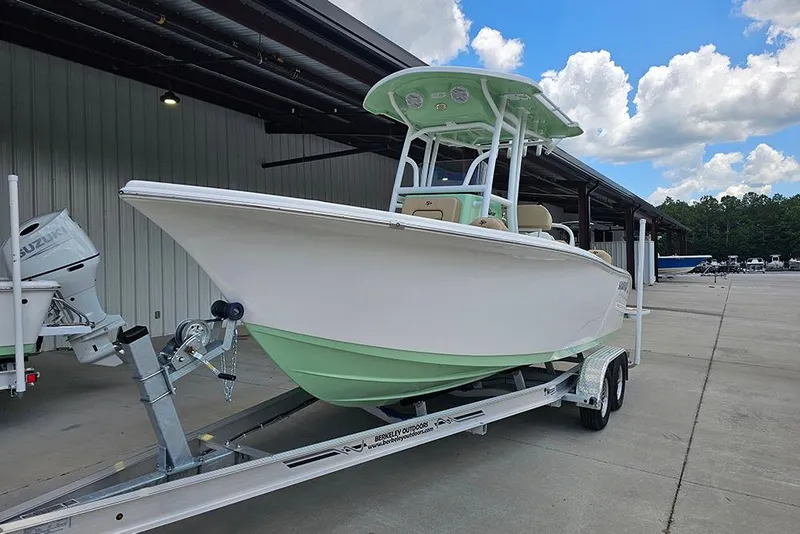 Slide: The Image of 2026 Sea Pro 225FLX Sandbar boat on trailer, parked outdoors under a clear sky. - 6