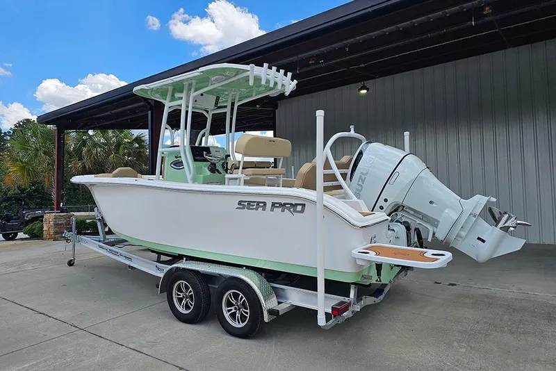 Slide: The Image of 2026 Sea Pro 225FLX Sandbar boat on trailer, parked outdoors under blue sky. - 8