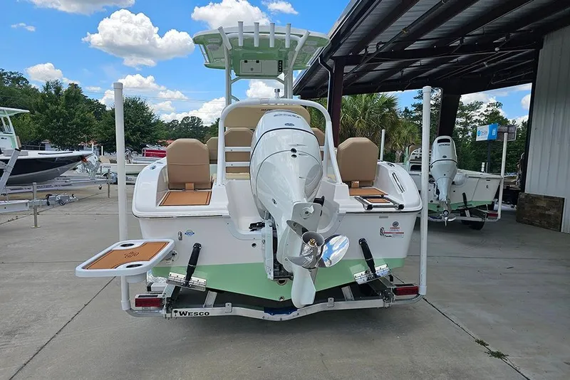 Slide: The Image of 2026 Sea Pro 225FLX Sandbar boat, rear view, in a marina setting. - 9