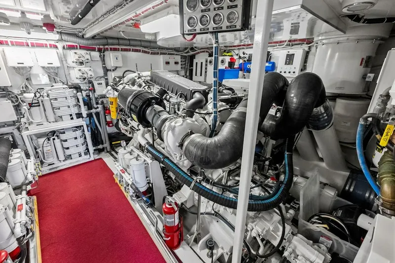 Slide: The Image of Engine room of a 2007 Hatteras 80 Motor Yacht, featuring complex machinery and equipment. - 52