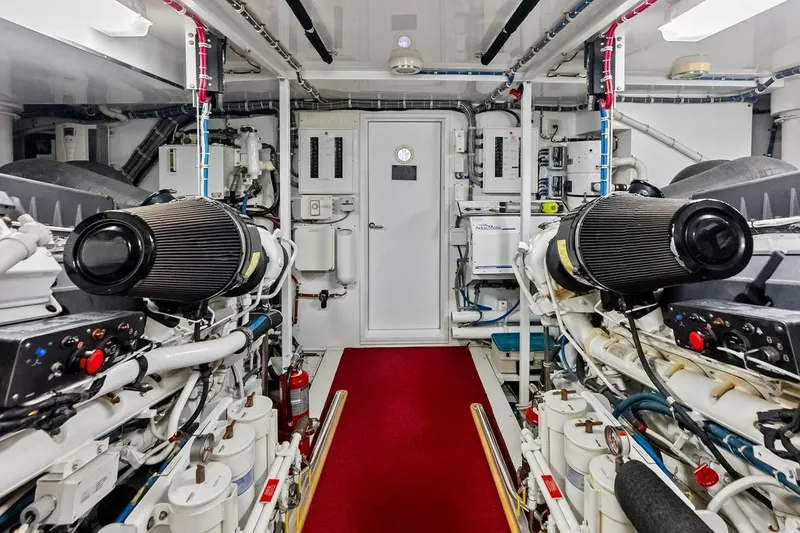 Slide: The Image of Engine room of 2007 Hatteras 80 Motor Yacht with dual engines and control panels. - 53