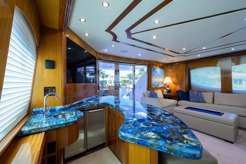 Slide: The Image of Luxurious interior of 2007 Hatteras 80 Motor Yacht with elegant blue countertop and plush seating. - 15