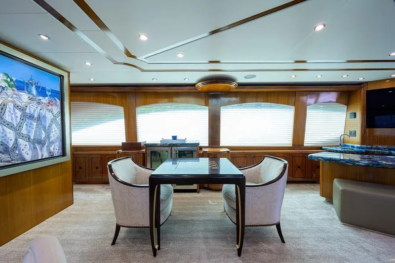 Slide: The Image of Luxurious interior of 2007 Hatteras 80 Motor Yacht with elegant seating and large windows. - 16