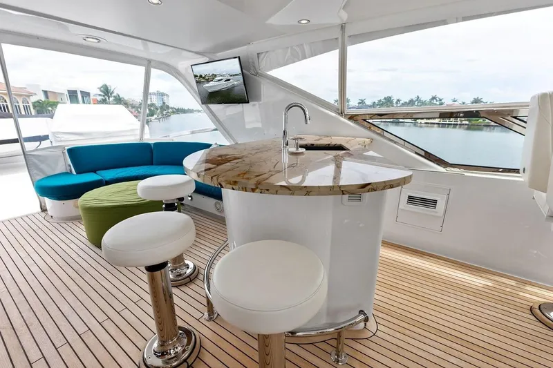 Slide: The Image of Luxurious interior of 2007 Hatteras 80 Motor Yacht with modern seating and elegant bar area. - 41