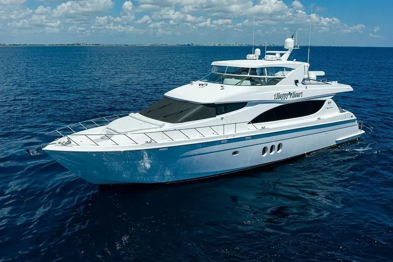 Slide: The Image of 2007 Hatteras 80 Motor Yacht cruising on open blue sea under clear skies. - 2