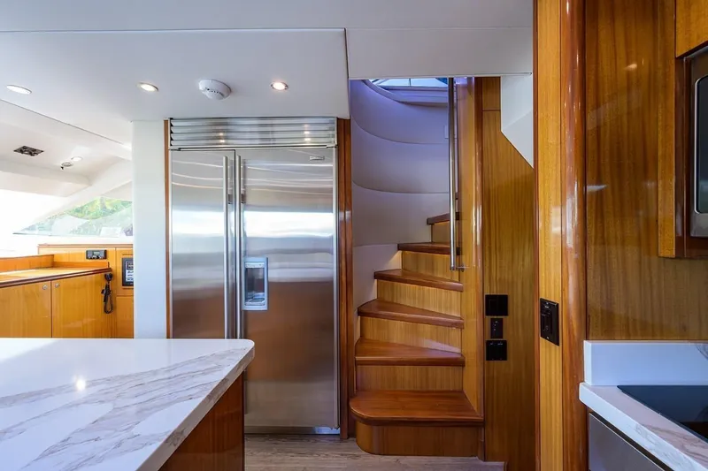 Slide: The Image of Luxurious interior of 2007 Hatteras 80 Motor Yacht with modern kitchen and elegant staircase. - 20