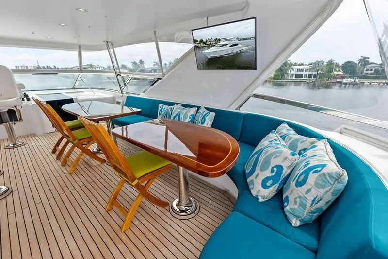 Slide: The Image of Luxurious 2007 Hatteras 80 Motor Yacht interior with elegant seating and scenic views. - 38