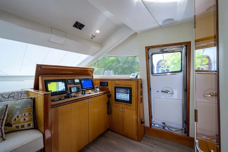 Slide: The Image of Cockpit of 2007 Hatteras 80 Motor Yacht with navigation equipment and wooden cabinetry. - 21