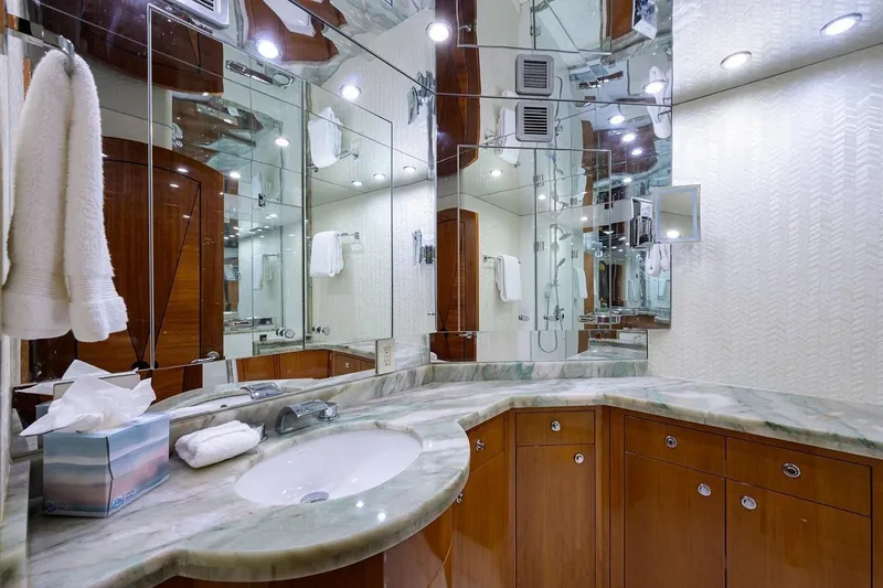 Slide: The Image of Luxurious bathroom in a 2007 Hatteras 80 Motor Yacht with marble countertop and mirrored walls. - 23